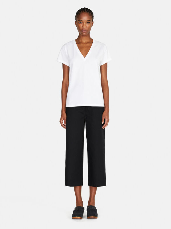 Cropped trousers with pockets Women